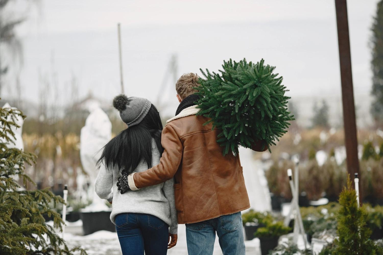 A couple picking up their Christmas tree, one of the most important relationship holidays.