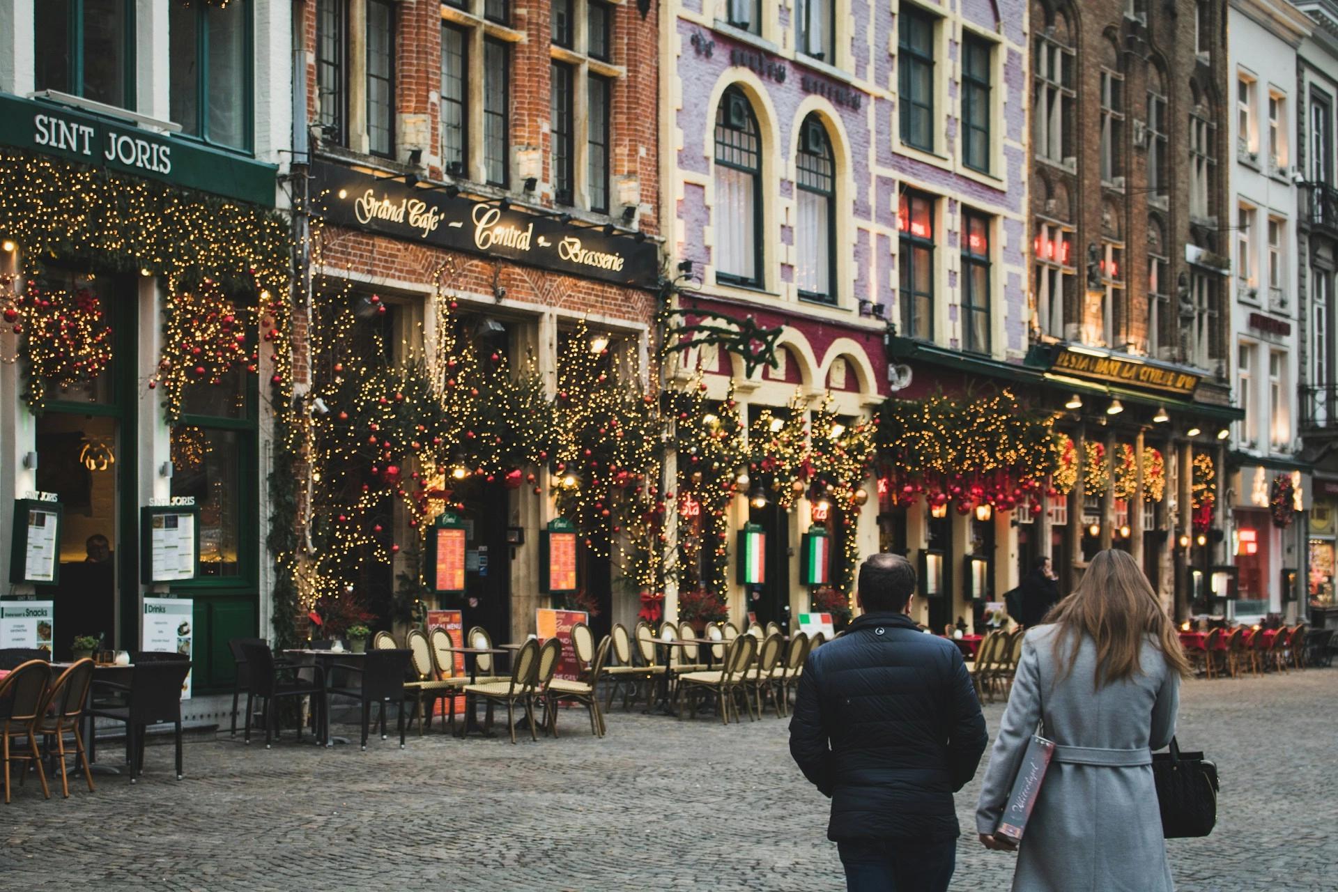 Some restaurants from Markt Square in Bruges, Belgium, decorated for Christmas, which is one of the best winter weekend getaways for couples.