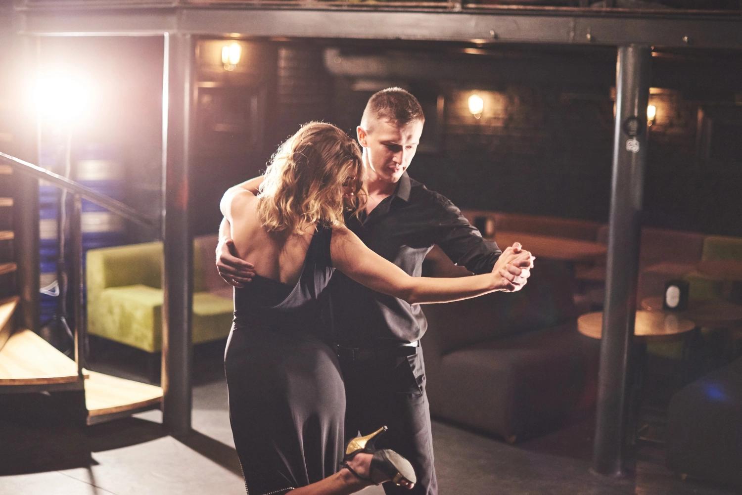 A couple taking dancing lessons, which is one of the best Valetine's Days date ideas.