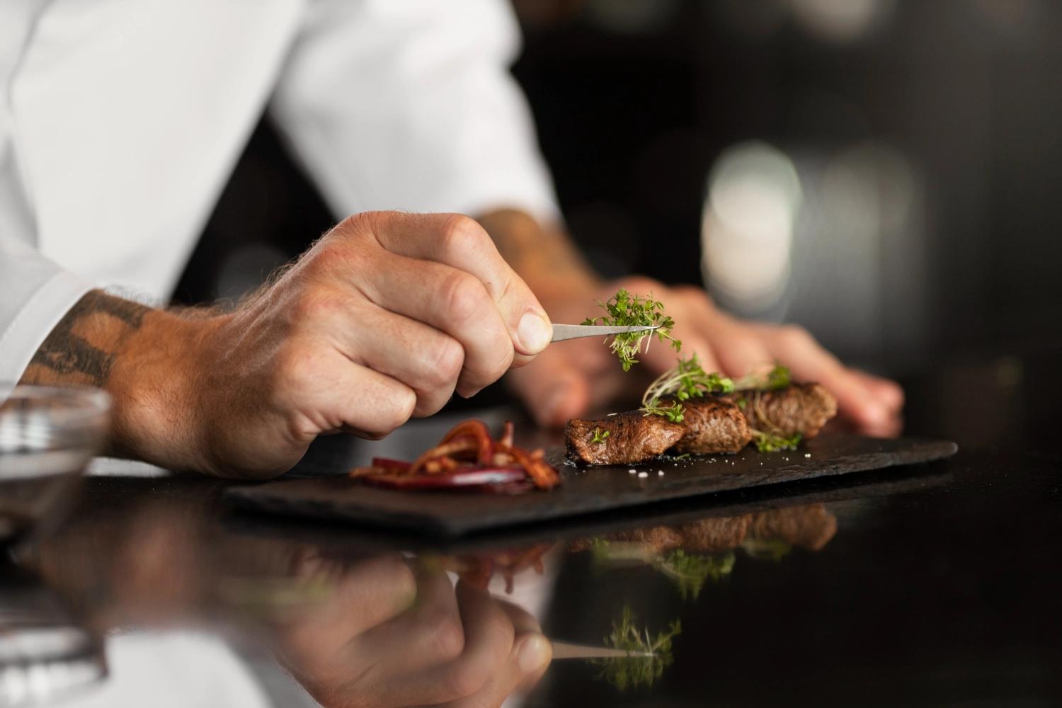 A close-up of a chef plaiting the food, which is one of the best Valentine's Day date ideas for couples.